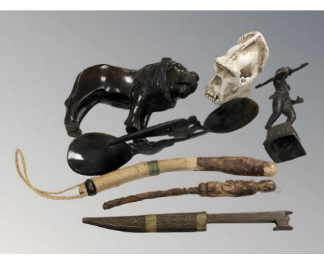A group of miscellaneous ethnic items including buffalo horn spoons, replica composition gorilla skull, figures, etc.