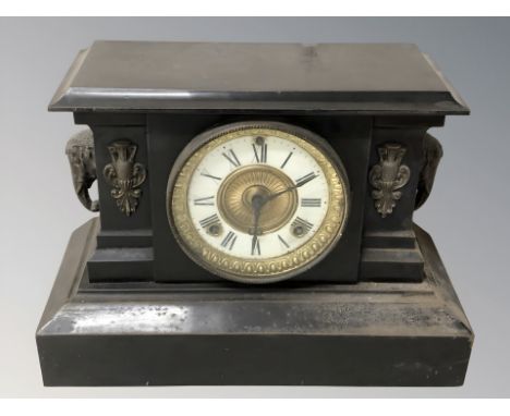 A Victorian black slate mantel clock with enameled dial, height 26 cm. (with pendulum) 