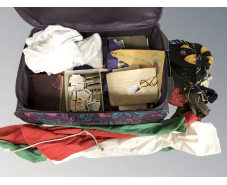 A luggage case containing Brooke Bond tea cards, schoolboy's caps and ties, books, etc.