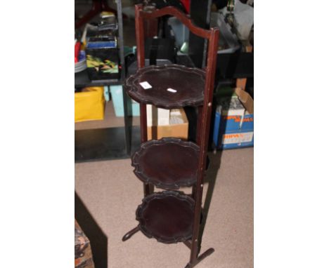 MAHOGANY FOLDING CAKE STAND, SMALL OPEN BOOKCASE, WALL MIRROR AND A TABLE LAMP