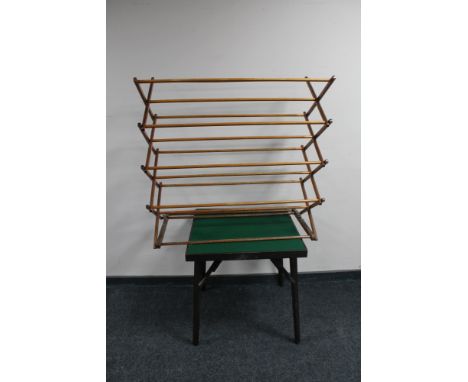 A folding card table and a wooden clothes airer 