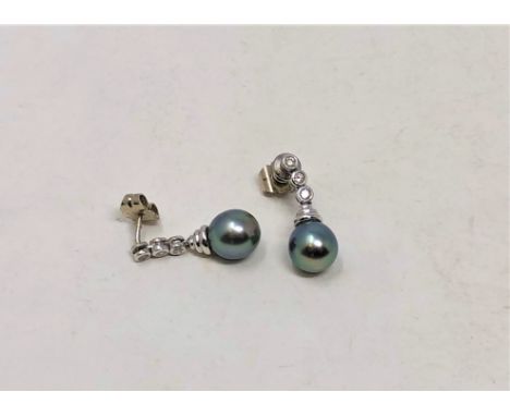 A pair of Tahitian pearl and diamond earrings