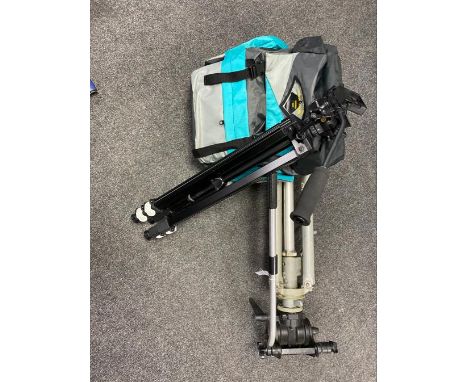 A vintage metal camera tripod together with a further tripod and a tough rucksack