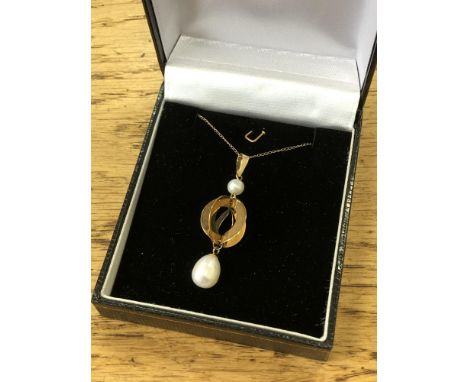 A pearl pendant set in yellow gold on chain