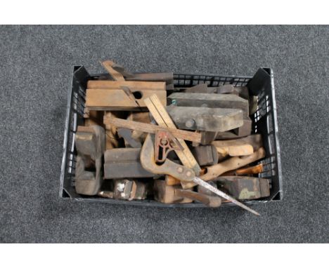A plastic crate of vintage wood working tools, wood planes, hand saw, vices, folding wooden rule etc 