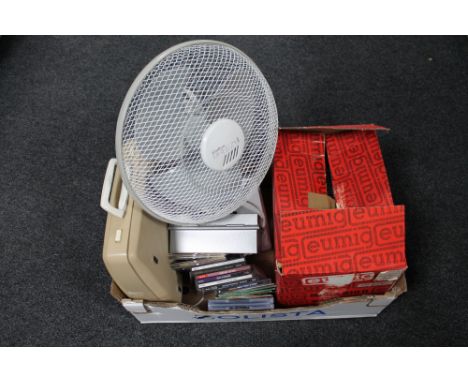 A box of electric fan, CD's, typewriter, reel projector, etc 