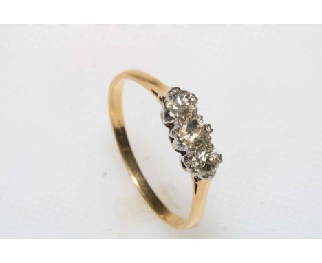 Three stone diamond ring set in 9 carat yellow gold, size T, boxed.