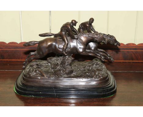 A large bronze model of steeplechasers jumping a brush fence on marble base, signed E. Loiseau, 31cm high.
