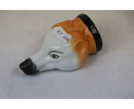 A ceramic stirrup cup in the form of a dogs head