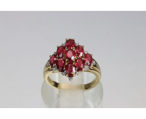 A Ruby and&nbsp; Dress Ring mounted in 9 ct Yellow Gold The top set with nine oval shaped uniform sized rubies with small dia