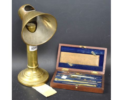 A Victorian cased drawing set; a brass students candlestick (2)