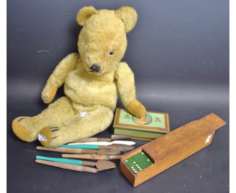 An early 20th century English jointed mohair bear, the back with a zip for a nightie;  a set of Bakelite dominoes, boxed;   c