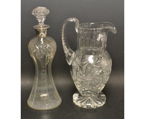 A late Victorian/Edwardian cut crystal heavy weight water jug; a silver collared waisted decanter, William Hutton and Son, Bi