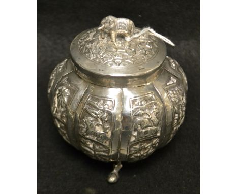 An Indian silver Decagonal lobbed bomb tea caddy, allover decorated with exotic animals, building and foliage, tripod feet