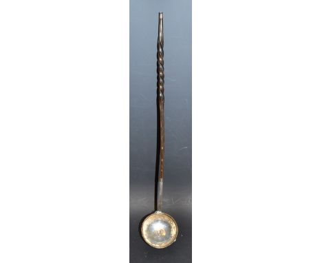 A 19th century silver toddy ladle, spiralled whale bone handle, inset fly bowl