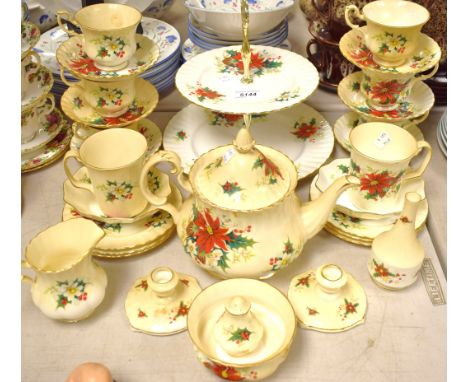 A Royal Albert Poinsettia pattern tea service for six comprising tea pot, two tier cake stand, sugar bowl, cream jug, side pl