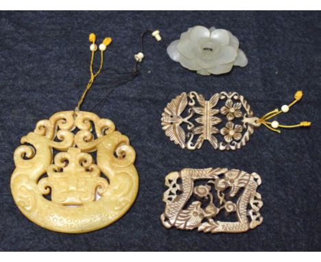 A Chinese jade flower; a hardstone disc; two ivory pendants