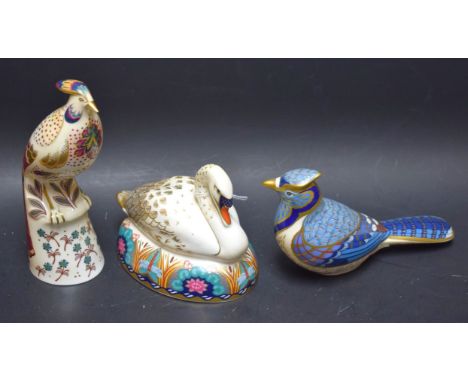 A Royal Crown Derby paperweight Swan; another; Blue Jay, silver stoppers; a Minton flights of fantasy bird model Marua design