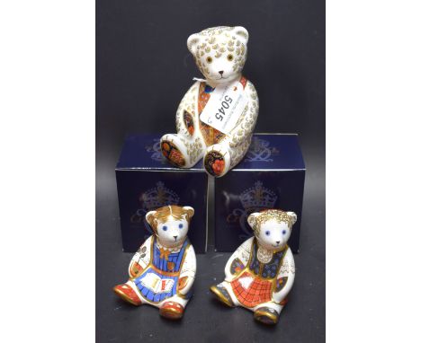 A Royal Crown Derby paperweight, Shona Bear, gold stopper, boxed; others, Schoolgirl Teddy, boxed; large Teddy, unboxed (3)