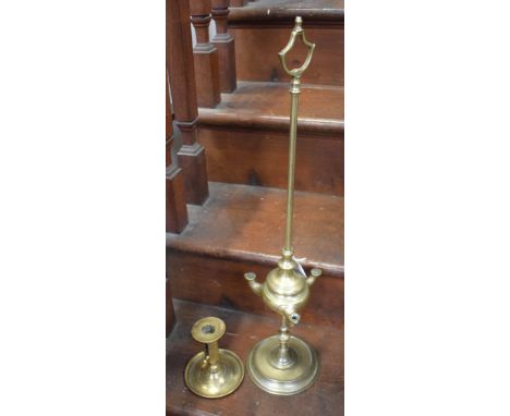 A 19th century brass whale oil spout lamp, axehead handle, knopped stem, circular base, 60cm high; a brass ejector candlestic