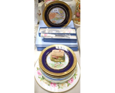 A set of four Limoges Castel plates, transfer printed with birds, the cobalt blue borders applied with raised gilt; a set of 