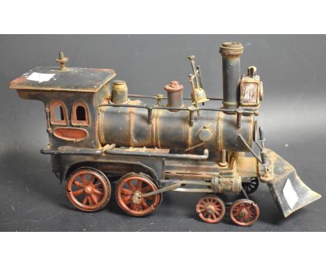 An early 20th century American 4-4-0 tin plate engine, picked out in red