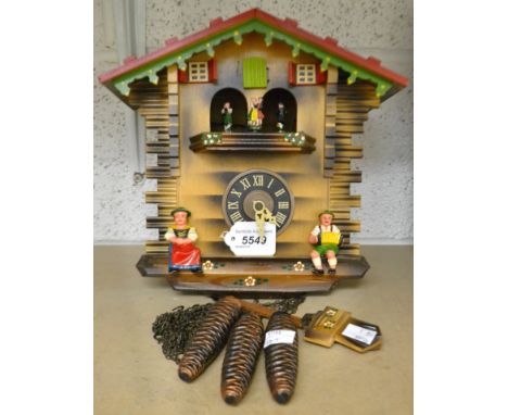 A cuckoo clock, pendulum, three weights