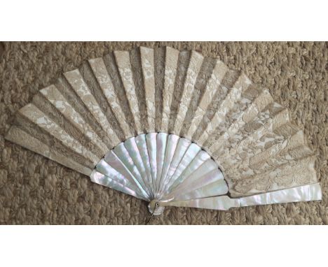 An early 20th Century fan having 14 mother of pearl wands A/F having a cream silk and lace cut-out design on one side and pla