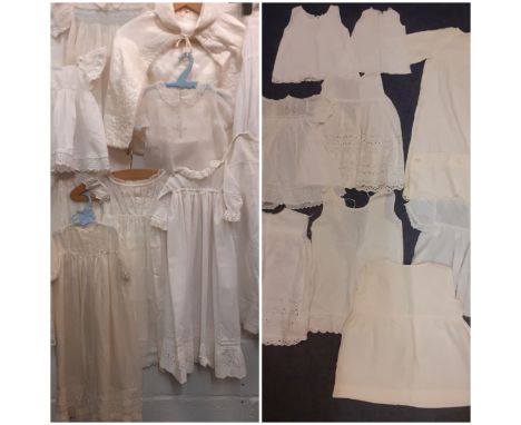 A quantity of vintage baby and young children's white and cream clothing to include a christening dress, a padded christening