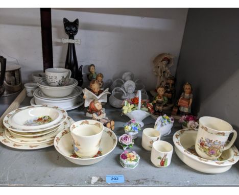 A group of Goebel Hummel figurines to include The Little Bookkeeper, selection of Wedgwood Peter Rabbit, and Royal Doulton Bu