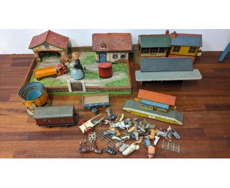 Toys to include Hornby tin plated railway buildings, a painted wooden model farm and lead animals, a clockwork dancing couple