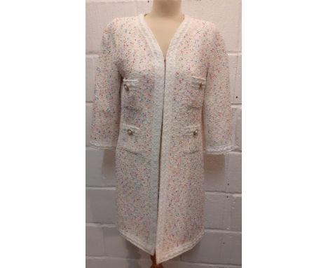 An Edward Achour, Paris white ground boucle coat in the style of Chanel having multi coloured flecks, ¾ sleeves, 4 front pock