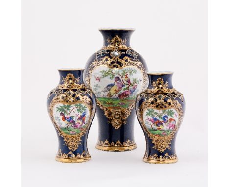 A Worcester mazarine-blue ground garniture of three baluster pot-pourri vases, painted with opposing kidney-shaped panels of 