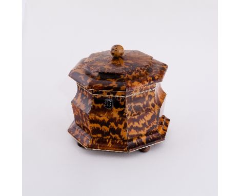 A fine and unusual tortoiseshell octagonal tea caddy, the cover with ball finial, the ogee shaped body with interior fitted b