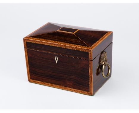 An early 19th Century rosewood tea caddy, cross banded and fitted one lidded compartment and an odd bowl, having brass ring h
