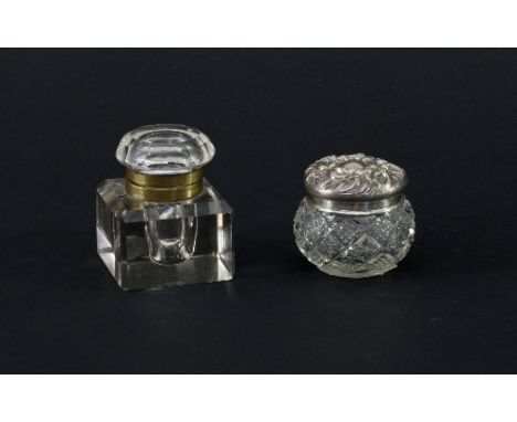 A square ink pot with brass mounts and hinged cover and a circular cut glass trinket bowl with embossed silver cover