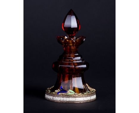 A late 19th Century octagonal amber glass scent bottle, with pointed stopper and serrated border, the jewel set base applied 