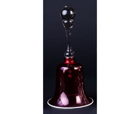 A ruby glass bell with white opaque glass border and clear glass handle, 33cm high