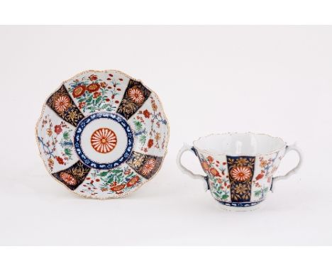 A Worcester two-handled chocolate cup and saucer, ogee form, painted with kakiemon panels, circa 1770, hatched square marks C