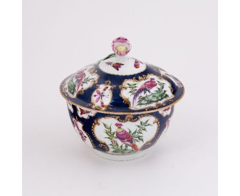 A Worcester blue scale ground sugar bowl and cover, painted with reserves of exotic birds within gilt cartouches, circa 1770,