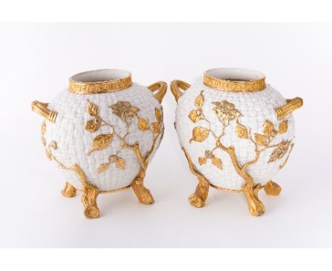 A pair of Royal Worcester two-handled vases, the woven-moulded bodies with gilt flowering branches from branch feet, printed 