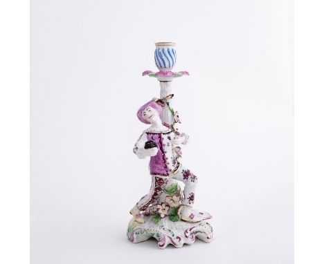 A Derby figural candlestick, modelled with harlequin in a dancing pose, mask in hand, circa 1760, 26.5cm high

 Condition Rep