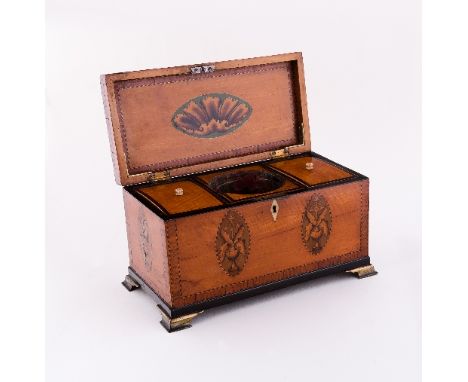 A George III satinwood rectangular tea caddy, cross banded and inlaid, shell and floral patera with inlaid spandrels to the c