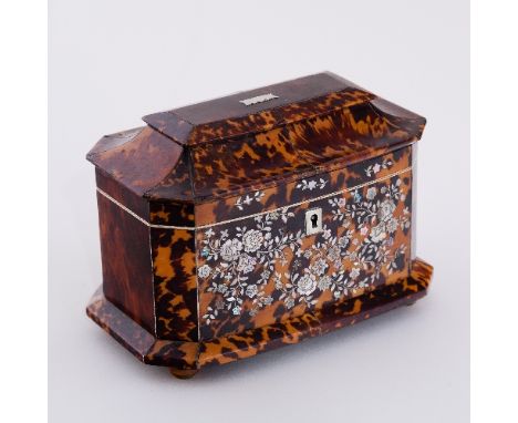 A Regency tortoiseshell sarcophagus shaped tea caddy, with canted corners, the front inlaid flowers and foliage in mother-of-