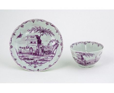 A Worcester porcelain teabowl and saucer, 'pencilled' in puce with a chinoiserie scene of two gentlemen in a fenced garden, c