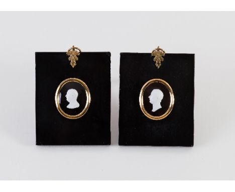 A pair of white opaque glass portrait busts of Pitt the Younger and George III, oval, 3.8cm x 3cm, in black papier maché fram