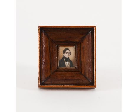 19th Century English School/Portrait of a Young Man/wearing a black coat/watercolour on ivory, 4.7cm x 4cm/in a rosewood fram