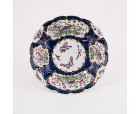 A Worcester blue scale ground lobed circular dish, painted to the centre with butterflies within further reserves of exotic b