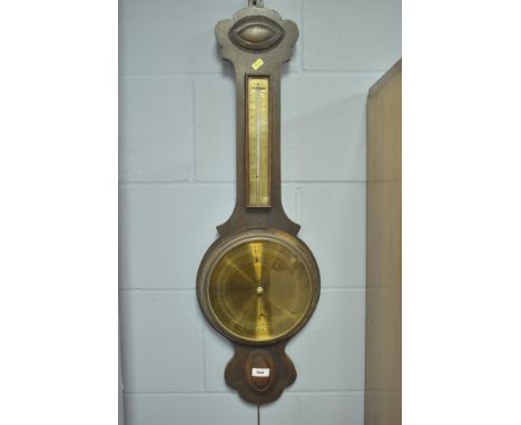 An early 20th Century oak wheel barometer, marked 'British Made'.