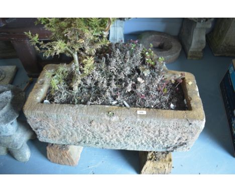 A faux-stone trough with two rests, 76cms wide.